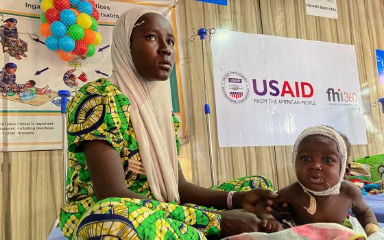 A woman attends to her malnourished child at the United Nations Nutrition Center in Banki, on the outskirts of Maiduguri, Nigeria, May 3, 2022. (AP/Chinedu Asadu)